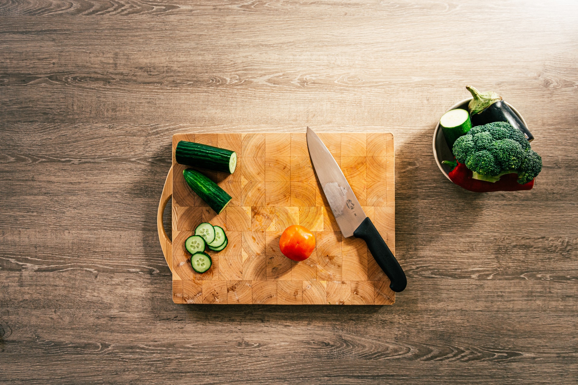 using knife, chopping board with vegetables and knife